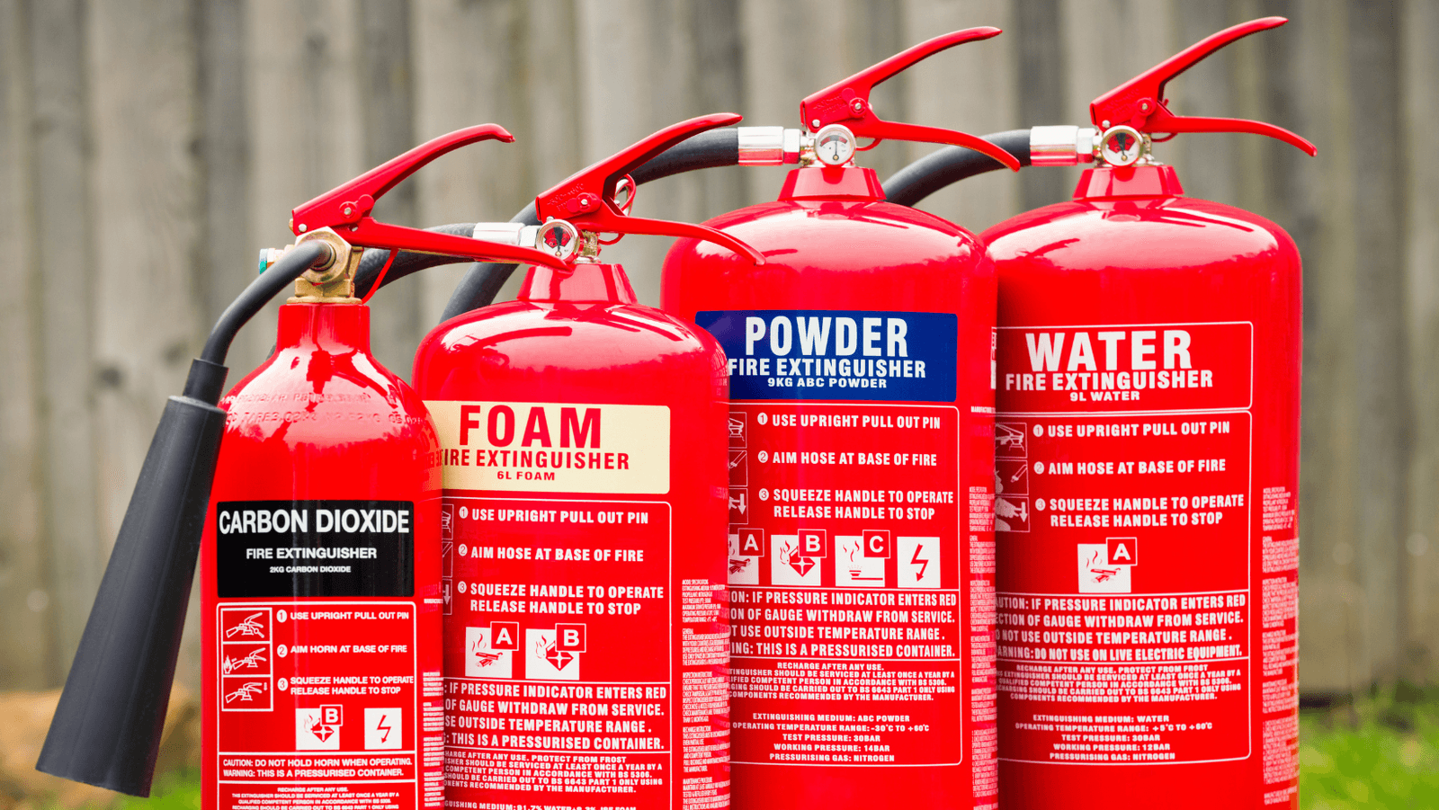 A row of serviced fire extinguishers ready for a commercial site